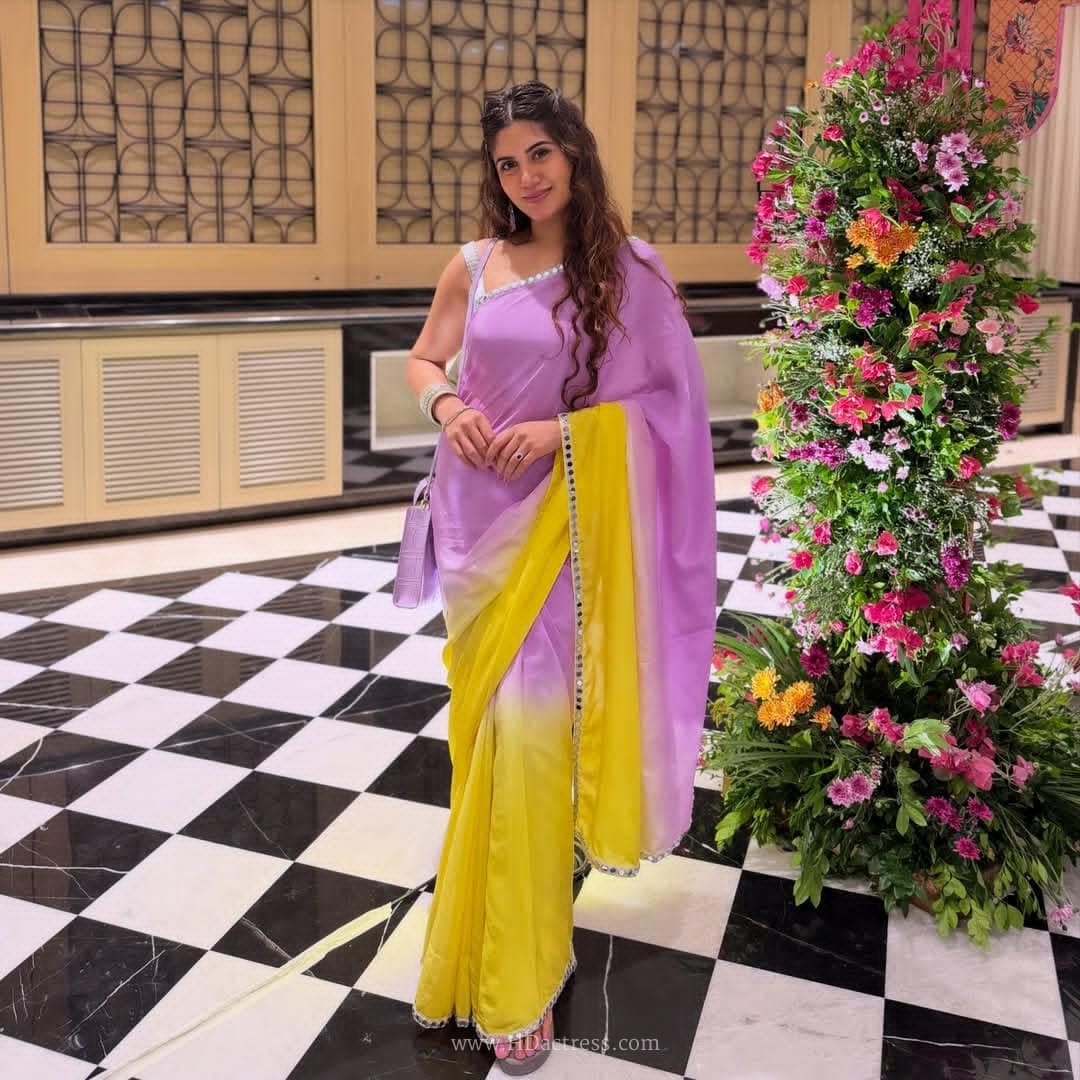 Krishika Anbalagan posing gracefully in a vibrant, elegant saree with traditional jewelry.