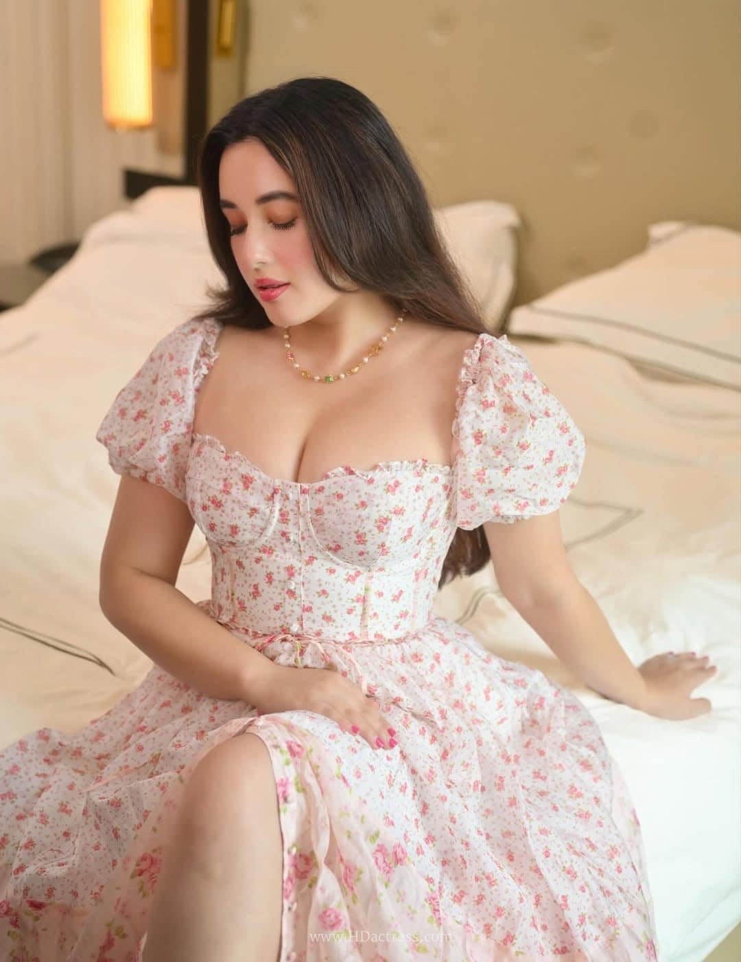 Close up portrait of actress Aditi Budhathoki styling a chic sweetheart neckline dress with voluminous short sleeves.