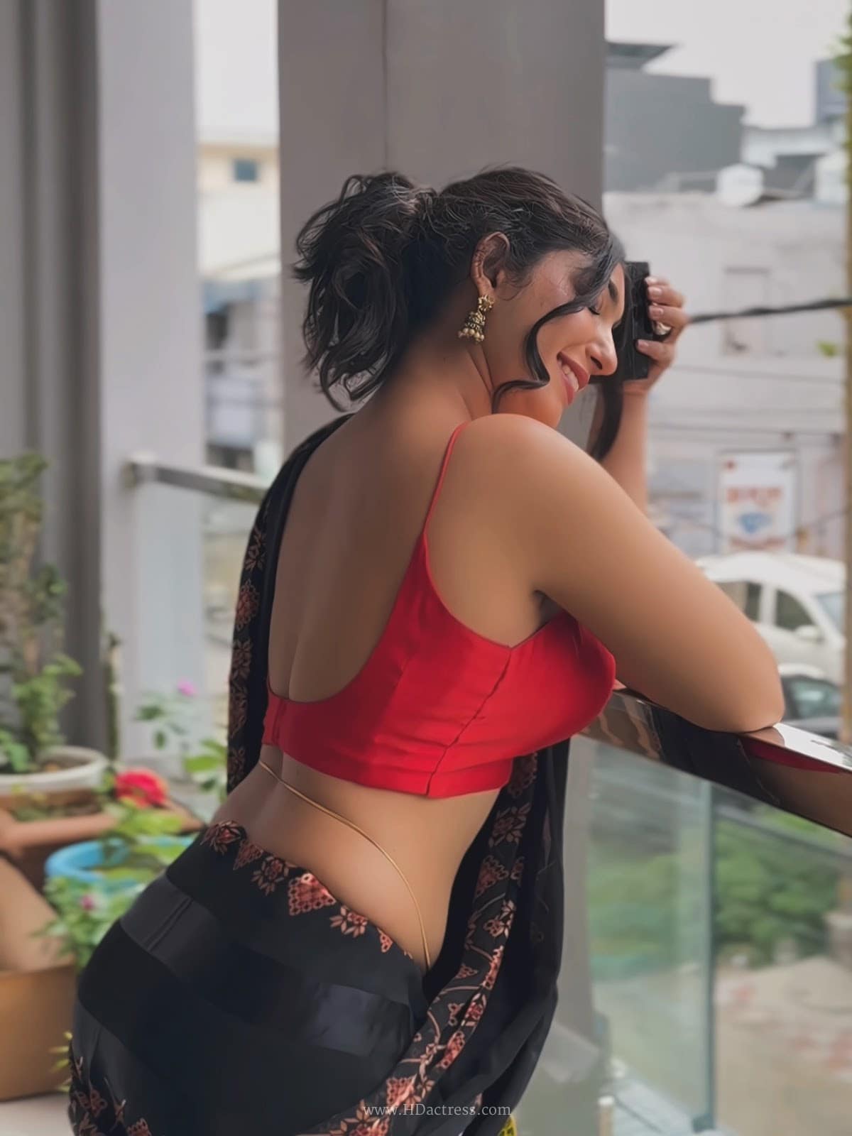 Divya in red blouse and black printed saree