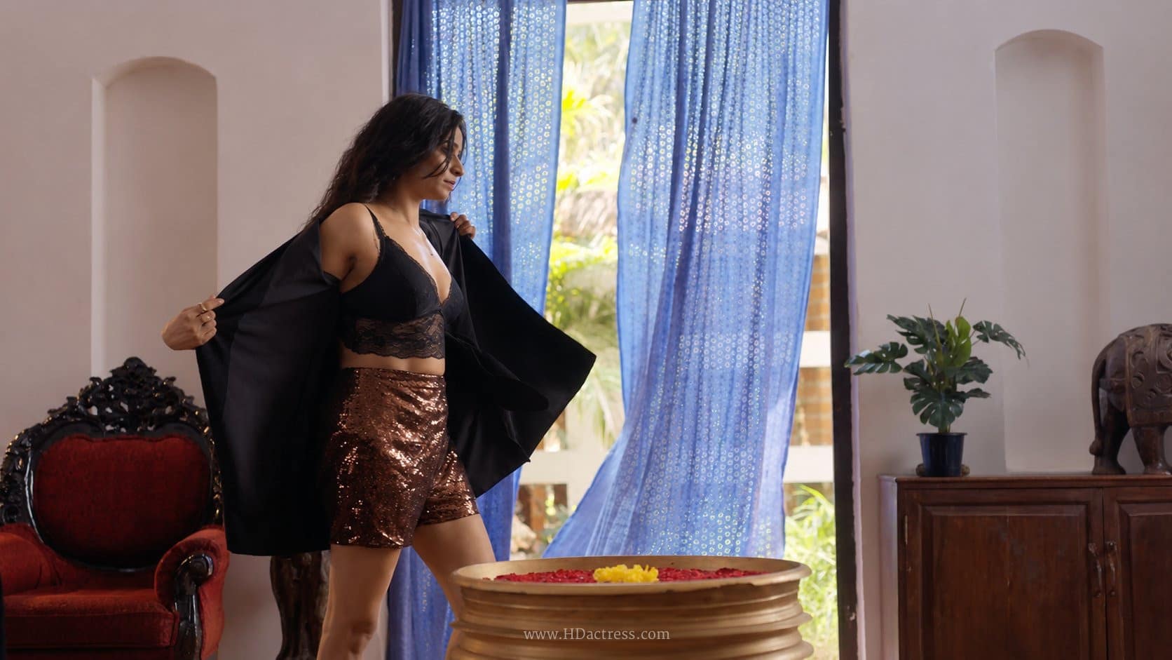 Divya Ganesh flaunting a bold look in a black lace bralette with a deep neckline from her web series Sshhh 3.