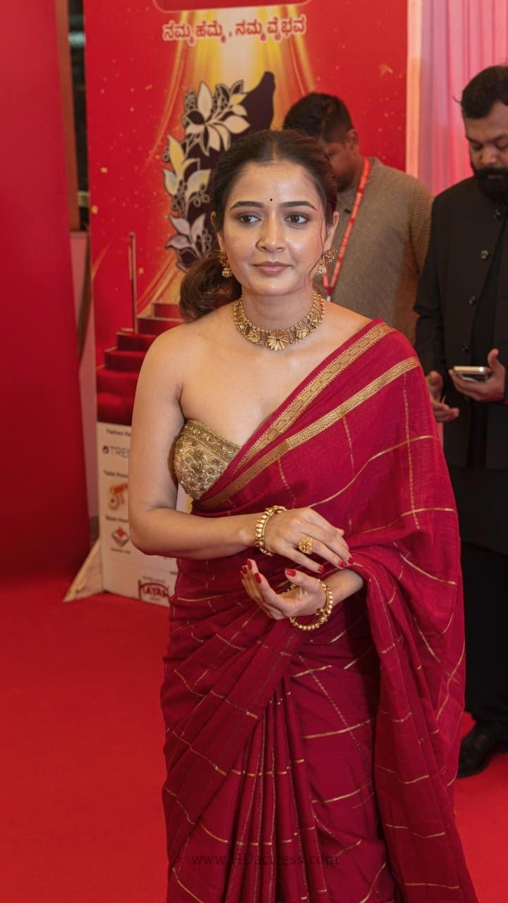 Ashika Ranganath saree photos, red saree outfit, celebrity saree trends, modern sleeveless blouse, ethnic wear inspiration, viral celebrity photos.