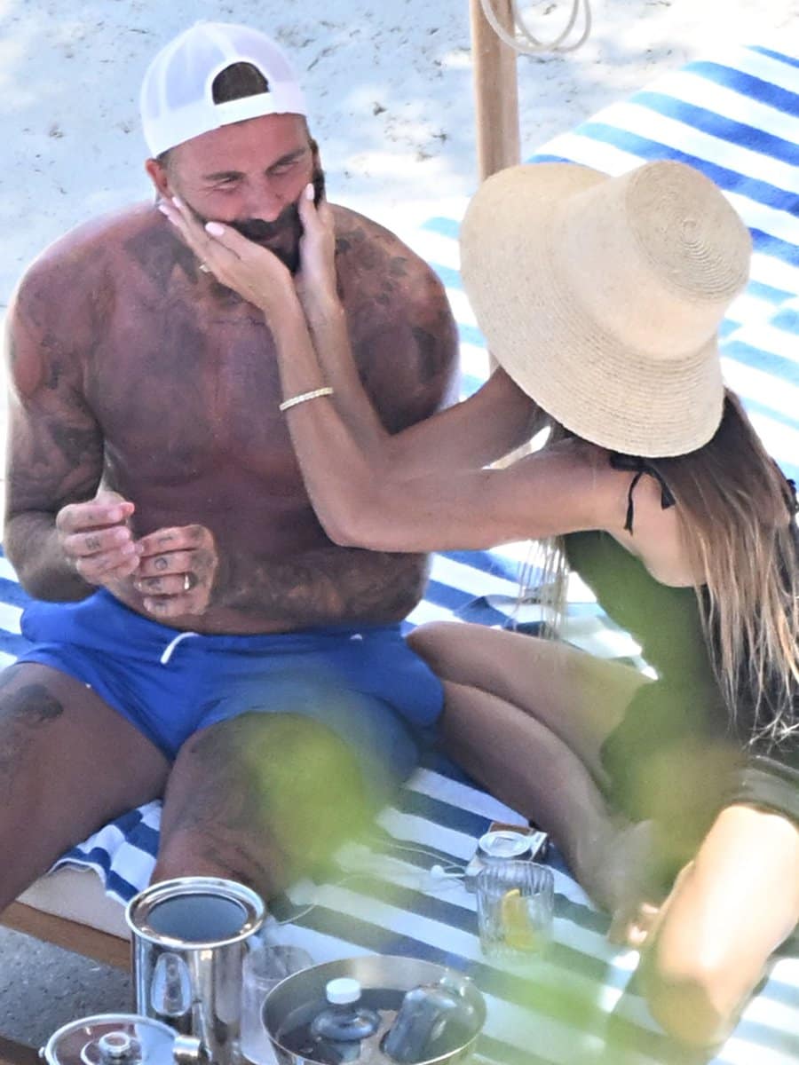 Pinned: David and Victoria Beckham shared a tender moment while relaxing on a sun lounger during their Italian getaway on the Amalfi Coast.